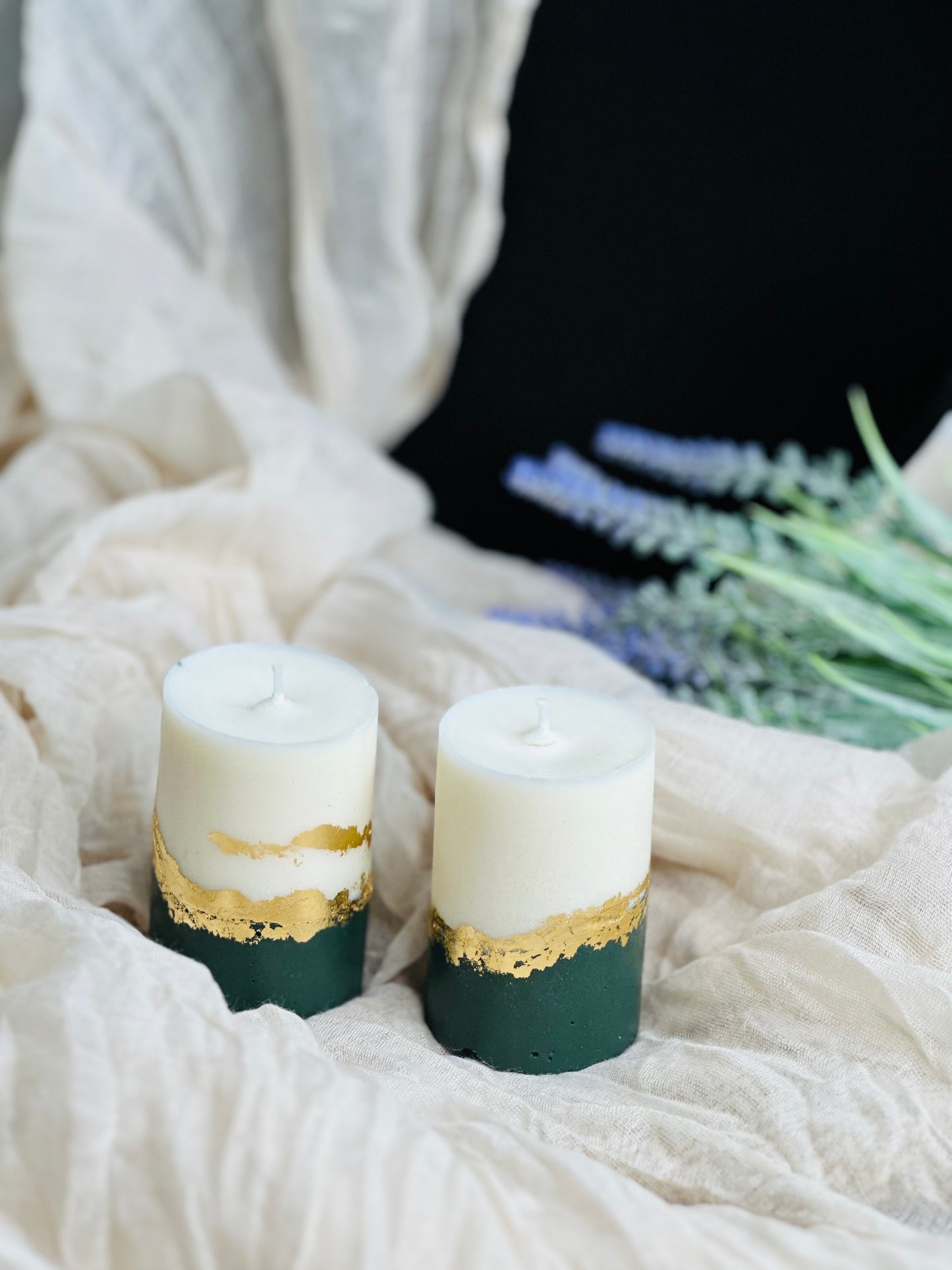 Two candles with gold accents on a white fabric background - UK made