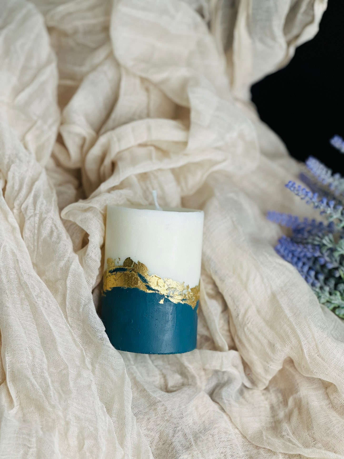 Ceramic mug with gold and blue design on a soft fabric background made in UK